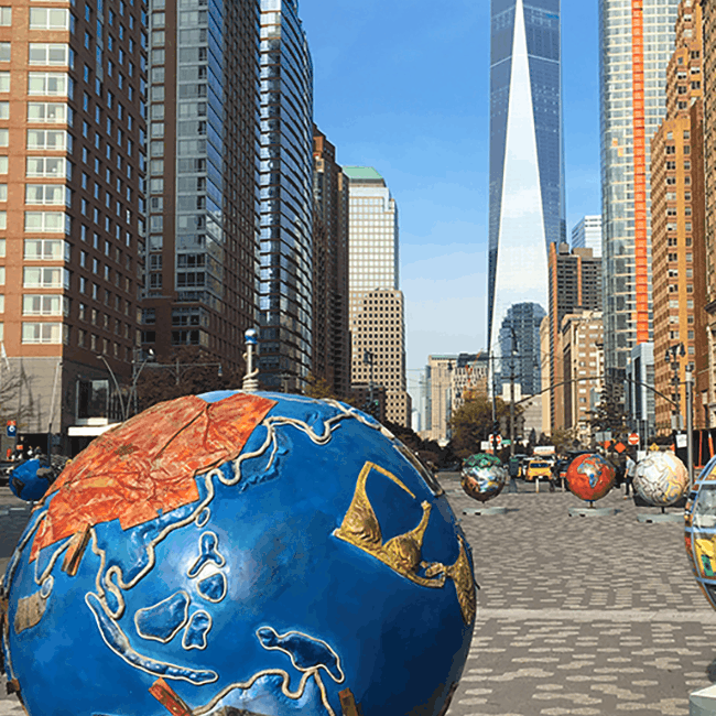 Image shows a sculpture of a globe with New York city buildings in the background above the text Packing for Plus Size Travel
