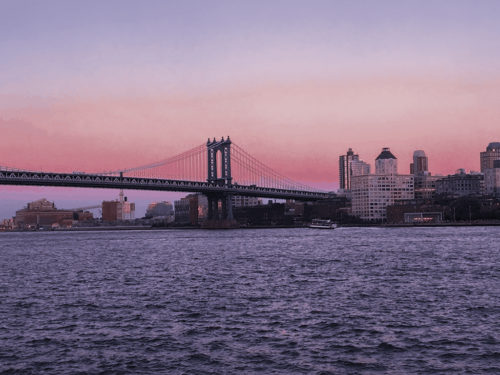 Image shows a pink and purpole sunset over the Brooklyn bridge above the words You Move To New York.