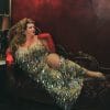 Image shows Jezebel reclining on a chaise in a sparkly silver dres and smiling into the camera above the title "26 Gifts For Traveling Showgirls and Burlesque Dancers"